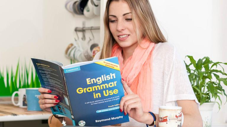 Spanish language student reading English Grammar in Use