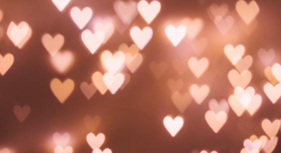 a dark pink background with numerous small pink heart lights